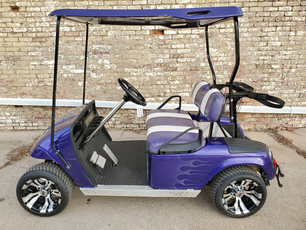 2002 E-Z-GO TXT, Electric 36-V (6-6V Batteries), Purple w/ Flames, Purple & White Seats, Purple Painted Top, Head & Tail Lights, Stainless Steering Column, Stainless Rear Bumper, Stainless Rockers, Stainless Foot Pedals, Stainless Engine Cover, Stainless Front Bumper Cover, New Trojan Batteries, 12